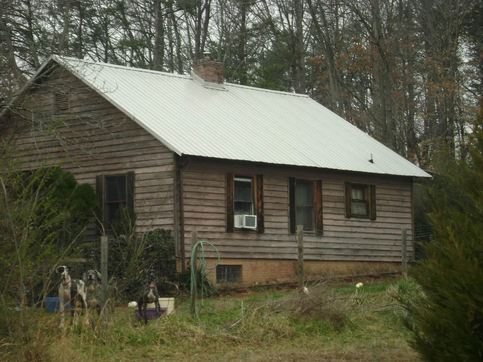 White metal roof on an old wood sided farmhouse, from a Metal Roof Installation job in New Harmony
